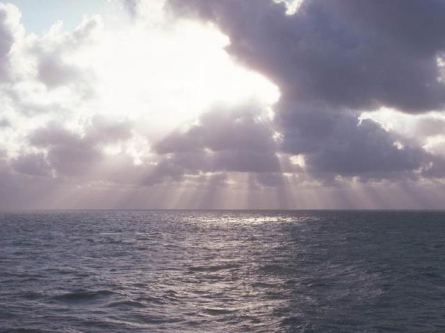 Above the gray plain of the sea