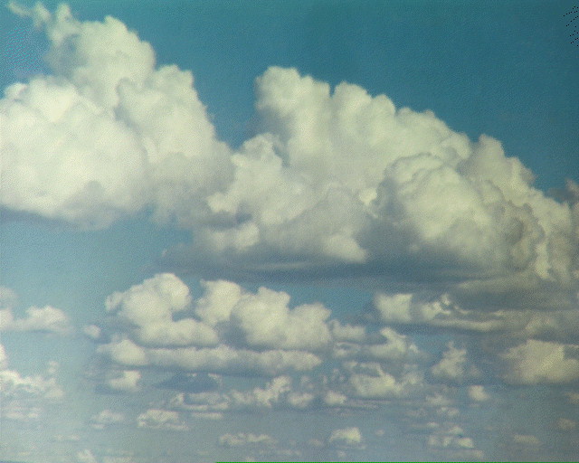 Cumulus clouds float like ships