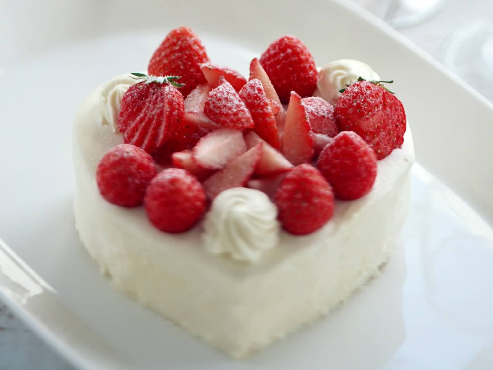 Heart-shaped cake decorated with strawberries