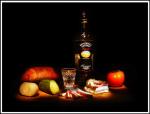 Photo of a bottle of vodka with snack on a table