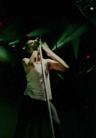 Dave Gahan with a mic stand in his hands