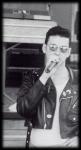 Photo by Dave Gahan with a microphone in black glasses